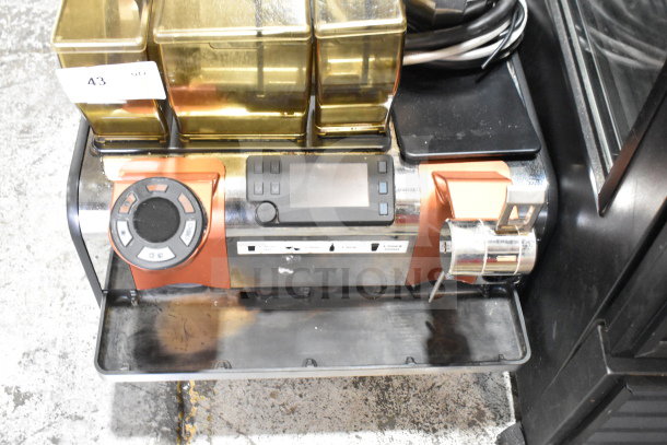 Thermoplan Mastrena M2-CS espresso machine with LCD display, dual hoppers, and steam wand. Stainless steel body.