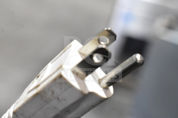 Close-up of a standard 115V plug, compatible with the True GEM-23 Cooler Merchandiser.