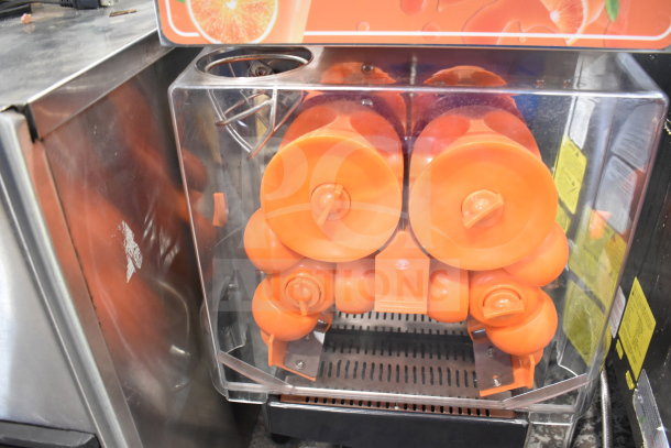 Vevor 2000E4 Commercial Citrus Juicer, orange and clear casing, 110 volts, 1 phase, in good condition.