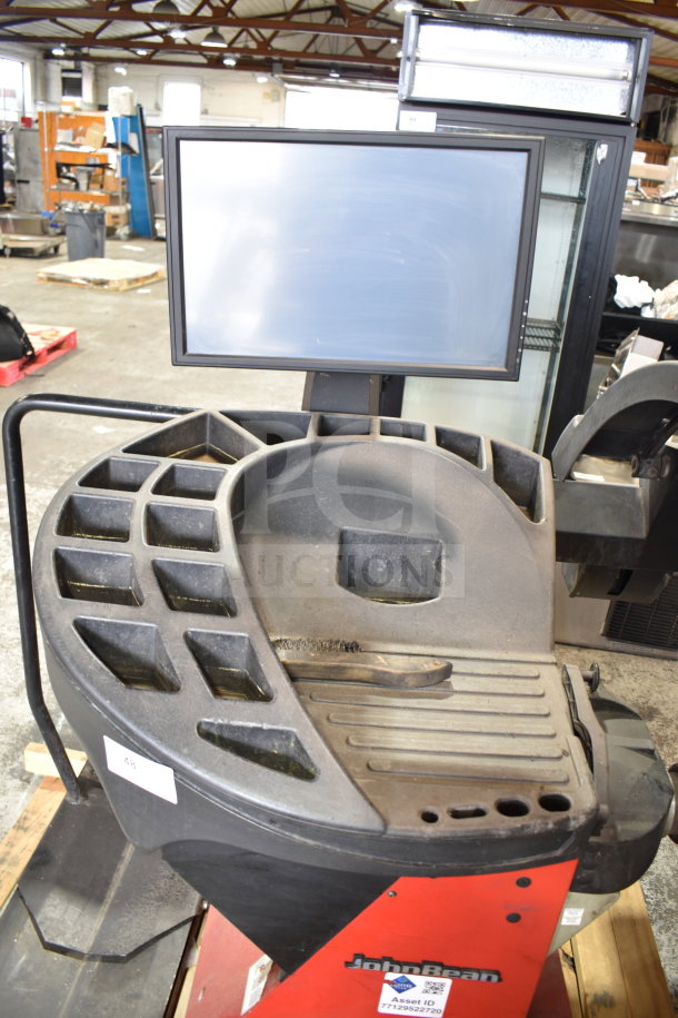 JohnBeam 1200P Commercial Floor Style Balancer, 230 volts, 1 phase. Features tool storage slots, screen, and user controls.