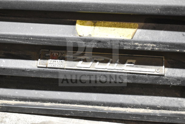 True GDM-72-LD commercial 3-door cooler, 115V, tested, working. Dusty exterior with True brand logo visible.