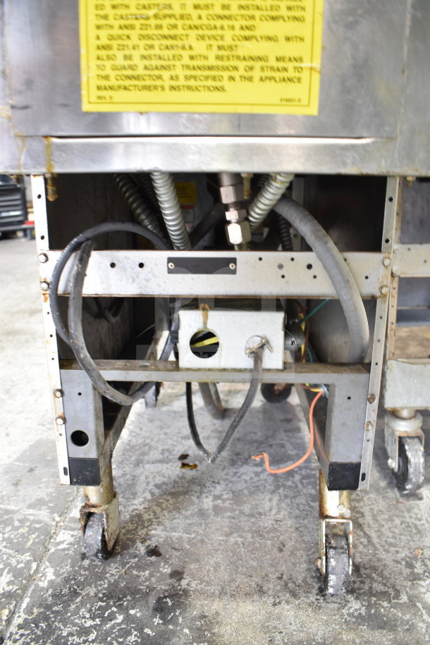 Vulcan 1ERD50 electric deep fat fryer on casters, 480V, 3-phase, visible wiring and mechanical components, industrial setting.