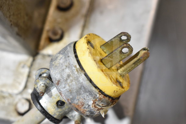 Close-up of a worn plug from a Hobart 2612 Commercial Meat Slicer, showing signs of rust and age.