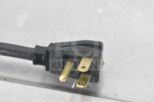 Close-up of the power plug for a 2016 True GDM-72-HC commercial cooler, 115 volts, 1 phase, in working condition.