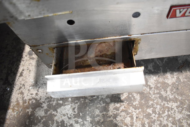 Vulcan commercial countertop gas griddle with visible drip tray. Signs of use and wear on metal surface.