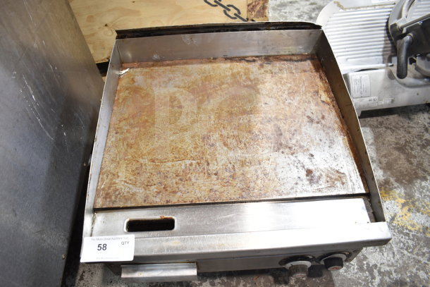 Vulcan commercial countertop gas-powered flat top griddle, showing signs of heavy use, steel surface, control knobs visible.