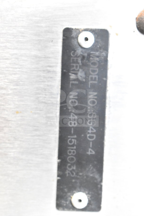 Vulcan SG4D-4 serial tag showing model number and serial number for commercial convection oven on stainless steel surface.
