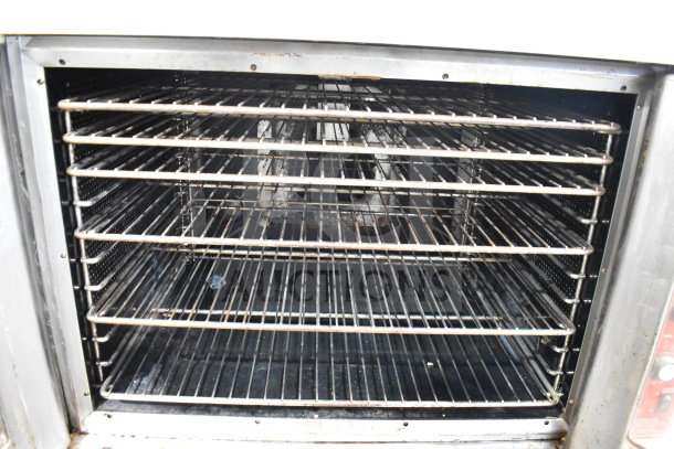 Vulcan SG4D-4 convection oven, stainless steel interior, multiple racks, view-through doors, thermostatic controls, on casters.