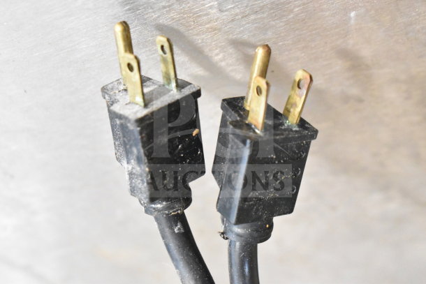 Close-up of two black electrical plugs for Vulcan SG4D-4 commercial convection oven.