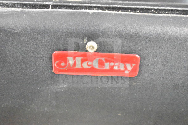 McCray SC-0030E-4-LS-B display case logo on black surface, featuring red McCray branding tag.