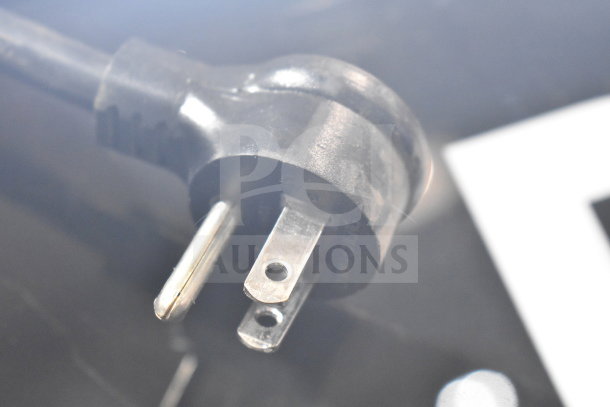 Electrical plug of 2019 True GDM-49-HC 2 Door Cooler; 115 Volts, 1 Phase, shown close-up, indicating functionality.