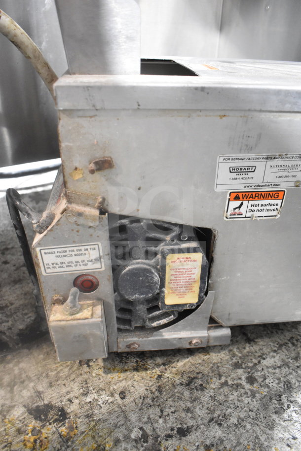 ME50 Commercial Portable Oil Filter, 120 Volts, 1 Phase, visible wear, warning and service labels, industrial use.