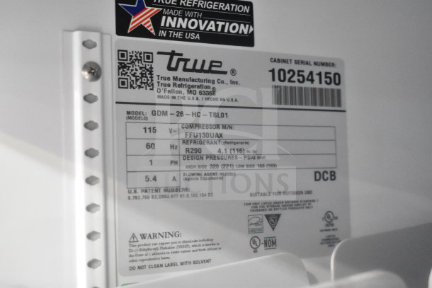 True GDM-26-HC label close-up, showing model, refrigerant type, voltage (115V), design pressures, and serial number.