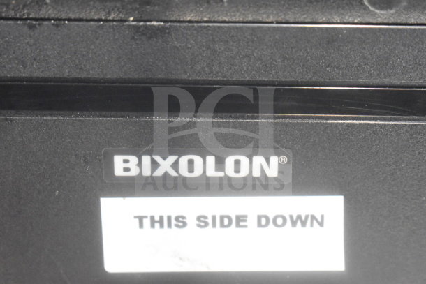 Bixolon SRP-S300 receipt printer, black, marked with "THIS SIDE DOWN" sticker, part of a four-item auction bundle.