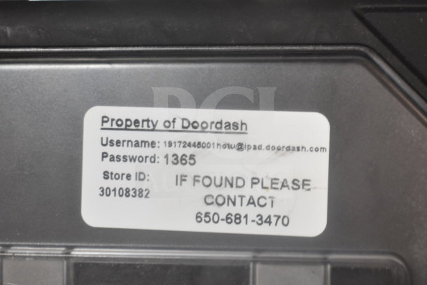 "Property of Doordash" label on an auction item, showing contact information and store ID.