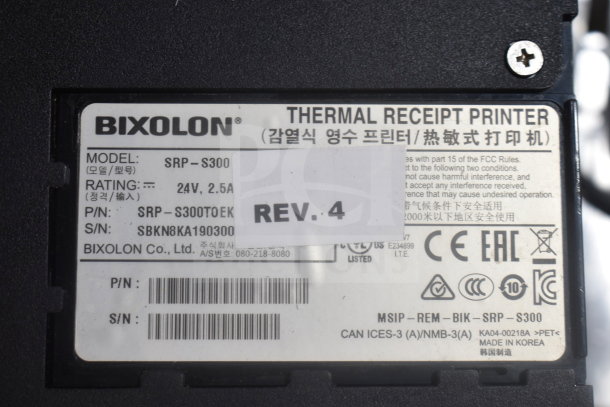 Bixolon SRP-S300 receipt printer label showing model, rating, and serial number details.
