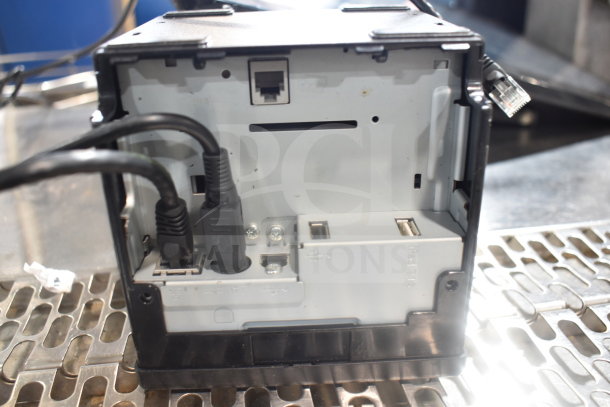 Bixolon SRP-S300 receipt printer back view; ports and cables visible, shows connectivity options.