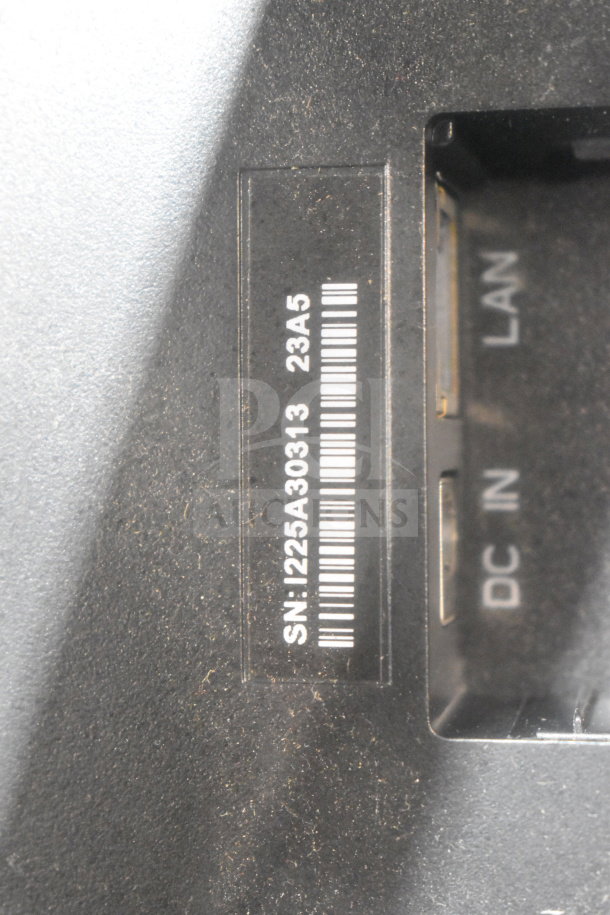 Serial number plate showing SN: 1225A30313 and LAN, DC IN ports on a device. Dust visible.