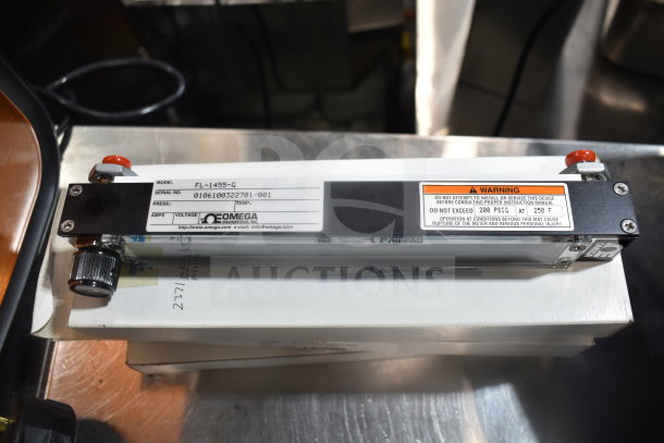 Omega FL-1455-G flowmeter, serial 0161600322701/001, with warning label; measures flow rate; lightly used condition.