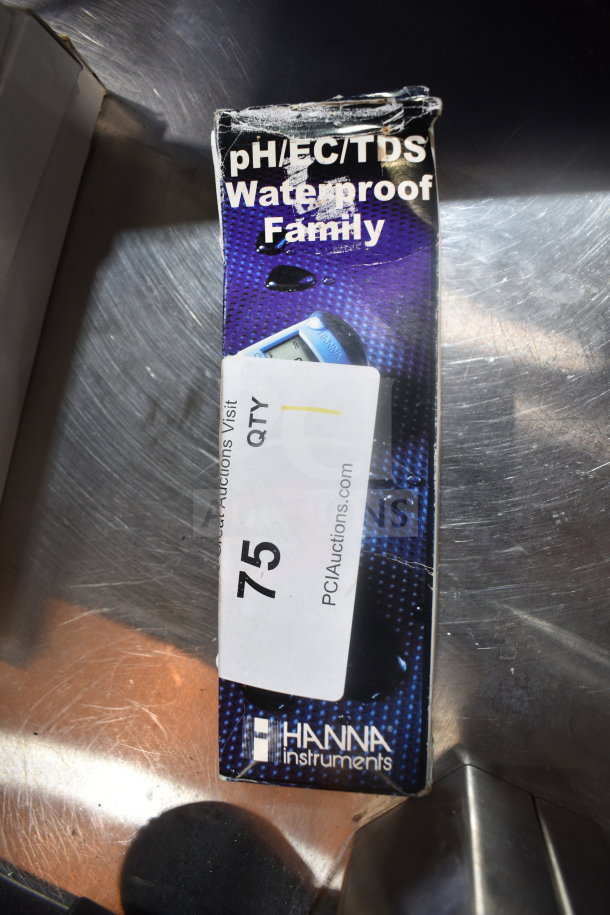 Hanna Instruments pH/EC/TDS Waterproof Meter in original packaging, slightly worn. Auction tag labeled "75" from PCI Auctions.