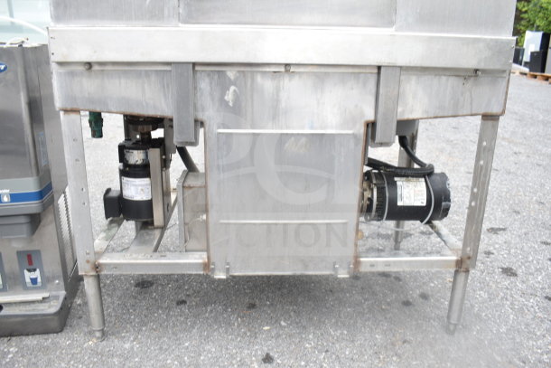 Hobart C44AW Commercial Conveyor Dishwasher, 3 Phase, sturdy metal build, visible components, used condition, outdoor setting.