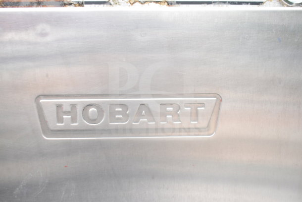 Hobart C44AW Commercial Conveyor Dishwasher. 3 Phase. Embossed "HOBART" logo on stainless steel exterior.