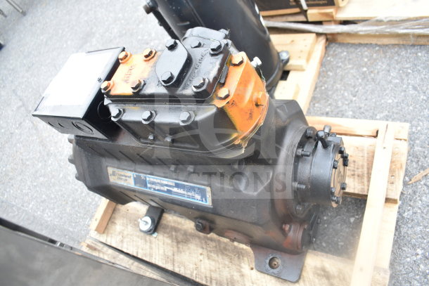 Copeland Discus 3DKHA120L-TFD-227 Compressor, used condition, visible label, resting on a wooden pallet.