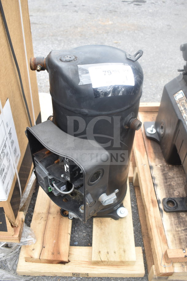 Emerson ZF34K5E-TFD-260 compressor, 3 phase, black, used condition, mounted on a wooden pallet.