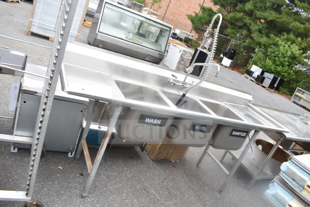 Advance Tabco commercial 3 bay sink with dual drain boards, labeled "Wash," "Rinse," "Sanitize," with pre-rinse faucet.