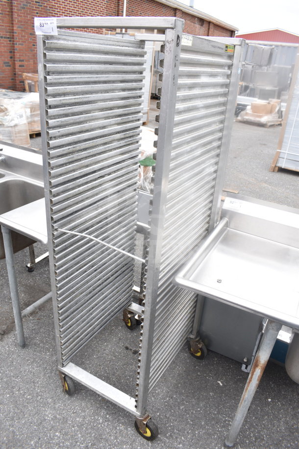CresCor 2001841 commercial pan transport rack with multiple slots, on sturdy casters, metal construction, outdoor setting.