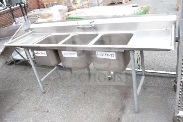 Commercial 3 Bay Sink with dual drain boards, stainless steel, labeled for washing produce, good condition.