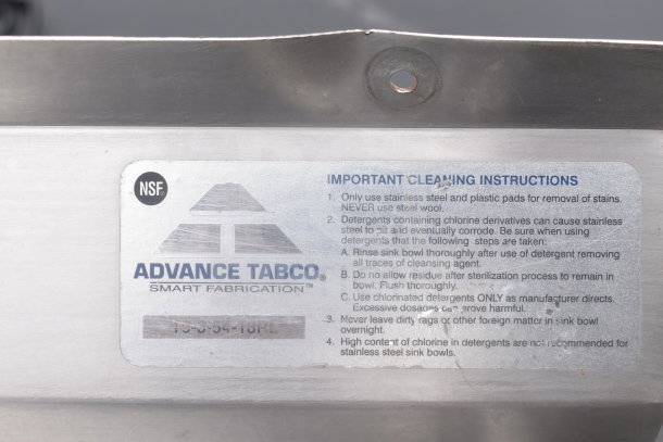 Commercial 3 Bay Sink with dual drain boards by Advance Tabco. Includes NSF label and cleaning instructions.