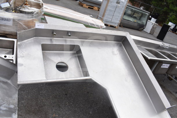 L-shaped commercial dish table, stainless steel, right side setup, missing legs, includes sink and faucet holes, good condition.
