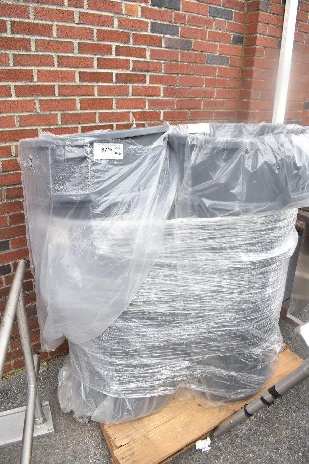 Set of six gray poly trash cans, wrapped in plastic, on a wooden pallet. Condition appears new.