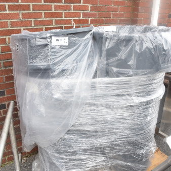 Set of six gray poly trash cans, wrapped in plastic, on a wooden pallet. Condition appears new.