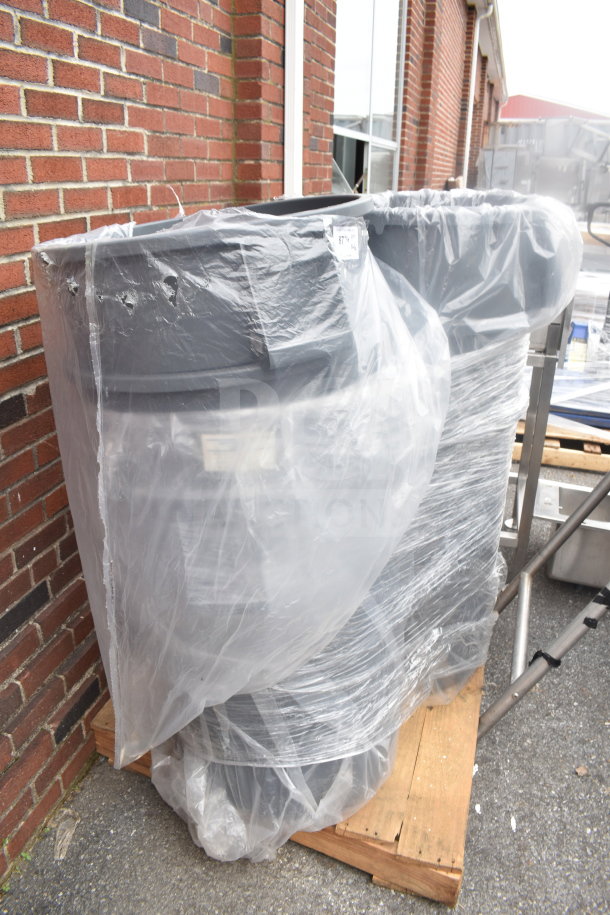 Six gray poly trash cans on pallet, wrapped in plastic. Each is durable, ideal for high-capacity waste management.