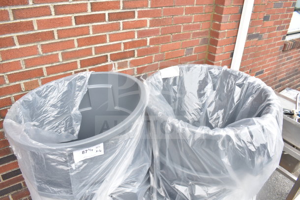 Six gray poly trash cans with plastic liners, showing a label indicating a quantity of six.