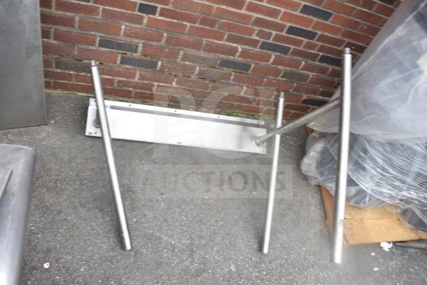 Stainless steel metal legs for furniture, four pieces, used condition, suitable for industrial or DIY projects.