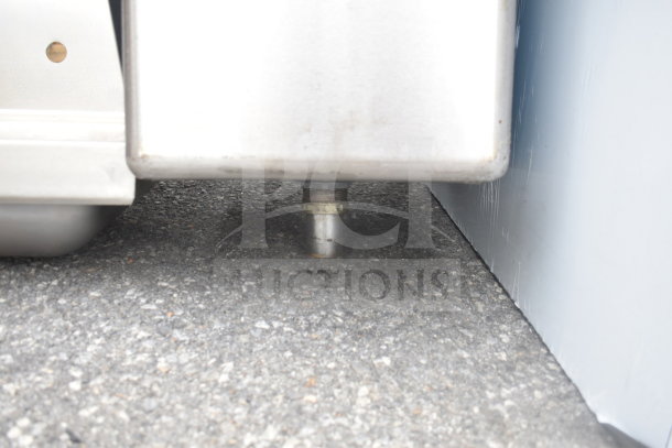 Elkay Single Bay Drop-In sink underside, showing plumbing connection. Stainless steel with some visible wear.