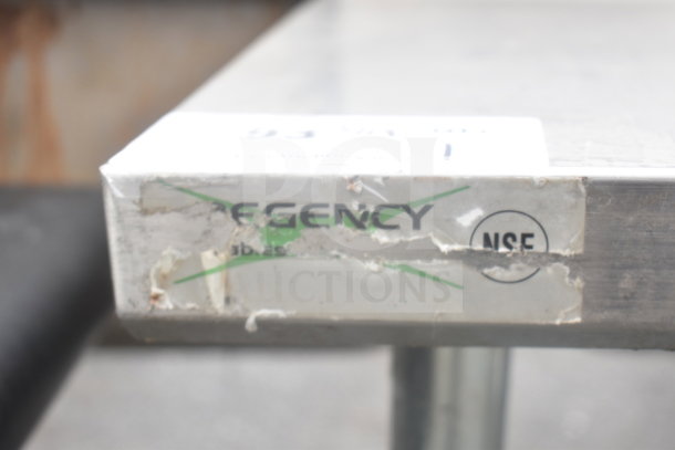 Regency Commercial Table with backsplash, visible NSF label, worn condition, includes under shelf.