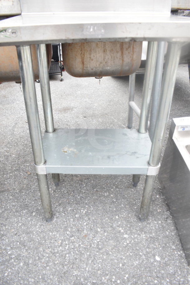 Regency Commercial Table with backsplash, under shelf, metal construction, visible wear, ideal for kitchen use.