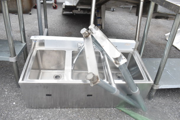 Steelton 522BS3T38 commercial 3 bay sink, stainless steel, with visible plumbing fittings, in used condition.