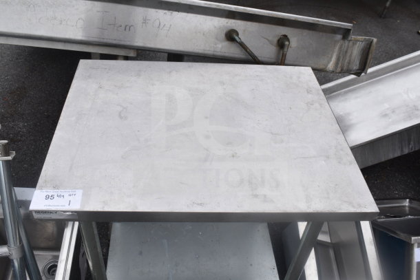 Regency stainless steel table with undershelf, industrial design, visible scratches and wear, auction tag reading "95."
