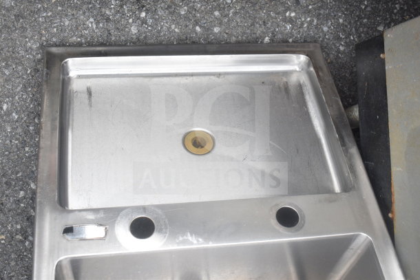 Stainless steel drop-in bay sink, single basin with a brass drain. Used condition with visible wear marks.