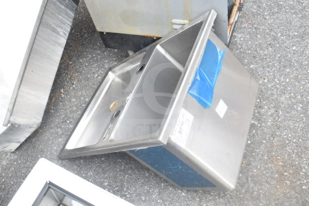 Stainless steel drop-in bay, rectangular shape, two faucet holes, with a blue taped label indicating item number 97.