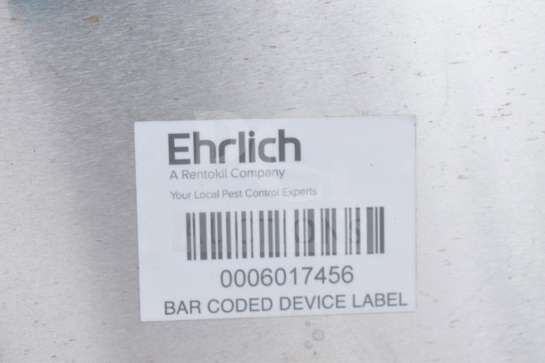 Ehrlich device label on metal surface, includes barcode and text: "A Rentokil Company" and "Your Local Pest Control Experts."