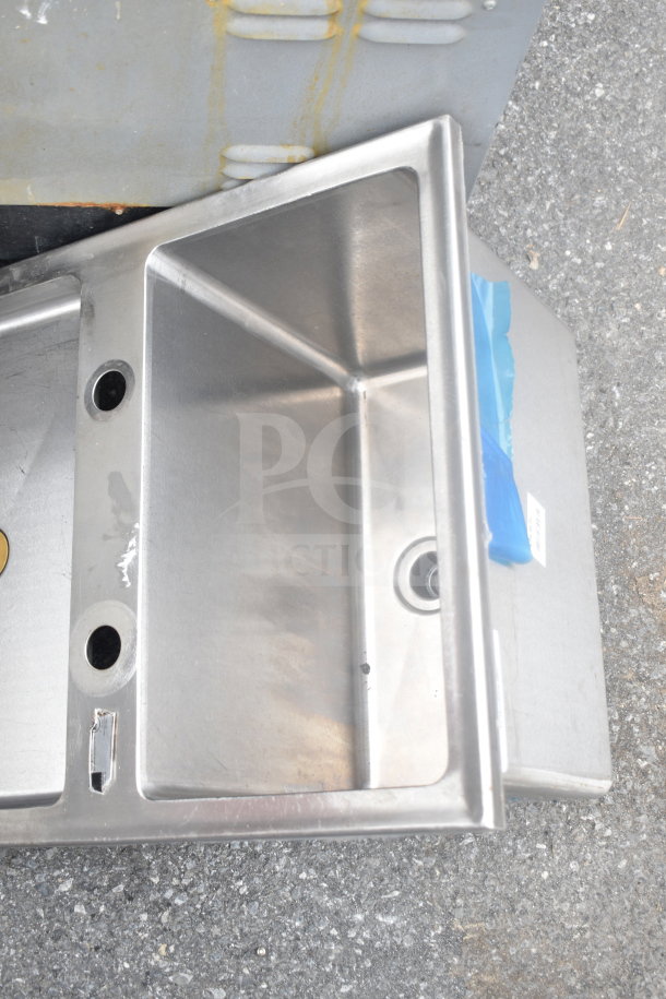 Stainless steel drop-in bay sink, rectangular shape, two faucet holes, visible wear, suitable for kitchen use.