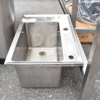 Stainless steel drop-in bay with visible wear. Includes draining outlet. Attached label reads "100.00 qty 1". 