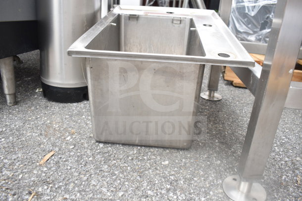 Stainless steel drop-in bay, used condition, with mounting holes and visible wear, suitable for kitchen use or industrial purposes.