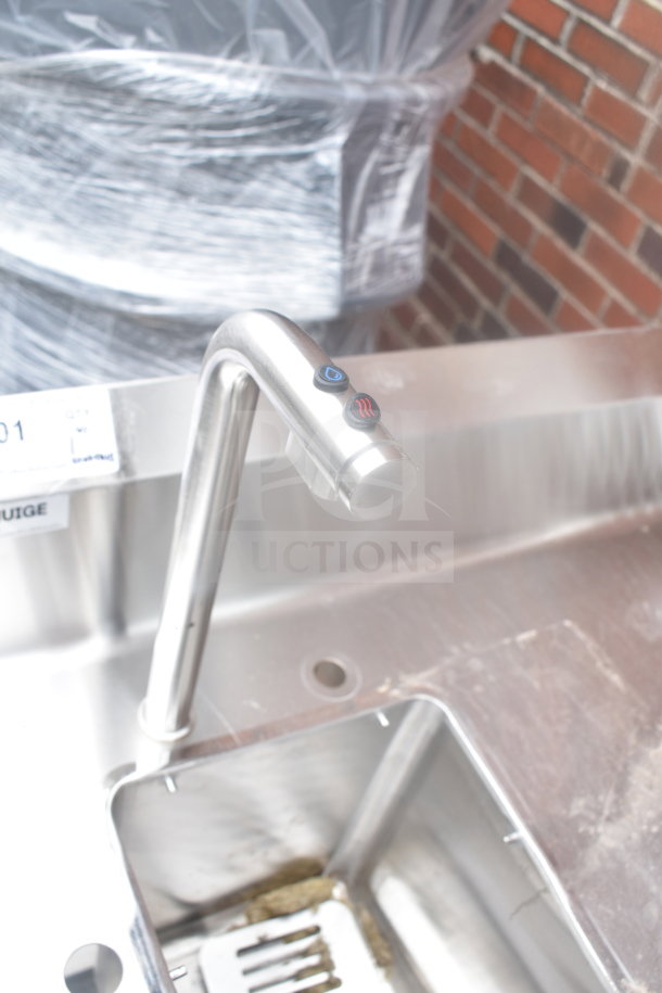 Stainless steel table with integrated sink bay featuring a Marco 10018805BX beverage system. Modern faucet design.
